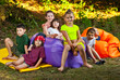 © Ivan - Children rest in nature. Boys and girls play on an inflatable sofa. Summer vacation in the garden.