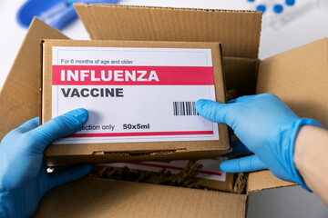 medical products distribution and shipping. opened box with influenza vaccine packages