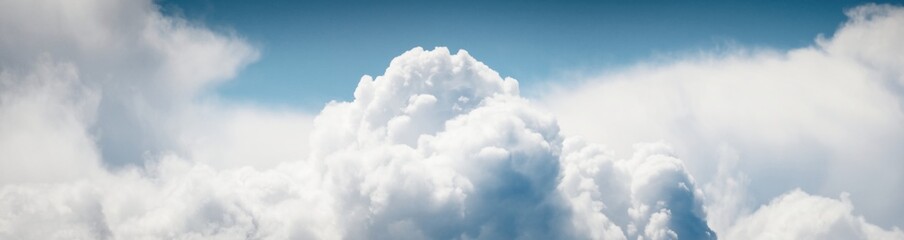 clear blue sky with glowing white cumulus clouds. midday sun. panoramic dramatic cloudscape. concept
