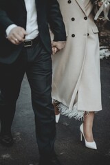 The bride and groom walk holding hands.
Created with RNI Films app. Preset 'Agfacolor 40's Aged'