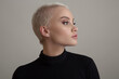© yuriyzhuravov - Portrait of a beautiful blonde woman with a short hair on a gray background.