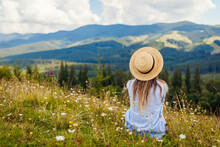 Traveling In Spring Ukraine. Trip To Carpathian Mountains. Woman Tourist Relaxing In Flowers Admiring View