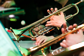 Wall Mural - Hands of man playing the trumpet in the orchestra