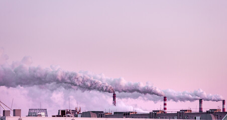 Wall Mural - copy space with industrial chimneys with heavy smoke causing air pollution on the pink and gray smoky sky background