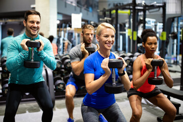 Canvas Print - Group of sportive people in gym. Happy fit friends workout, exercise in fitness club