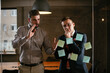 © JustLife - Businessmen in the office. Colleagues in conference room making a business plan. Two man working together on new project.