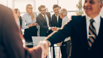 Wall Mural - close up. confident business people shaking hands at a business