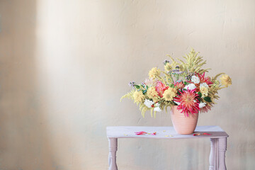 Wall Mural - yellow and red flowers in vase on vintage shelf