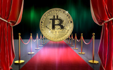 Big Gold Coin Of Bitcoin On Red Carpet With Velvet Curtains.