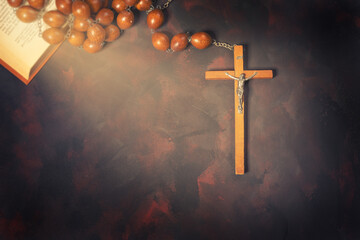 Big wooden Rosary beads and crucifix cross with jesus,red candle and bible book,spiritual atmosphere ,religion concept.