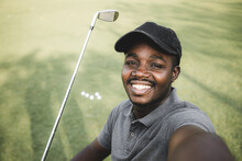 African American Of Young Man And Happy Making Selfie Photo While Standing Together With Golf Putters During A Game On The Golf Course.