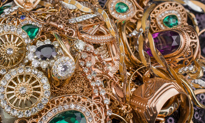 Pile of gold jewelry on black background