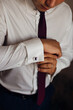 © Ivan - the groom fastens the cufflinks on the shirt of the groom's morning gatherings before the wedding.