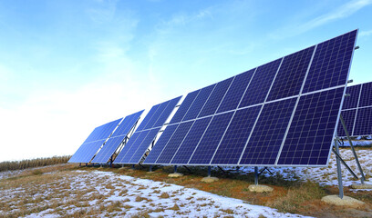 Solar panels Photovoltaic cells on a background of sunrise. Solar panels, the beginning of winter. Alternative ecological energy.