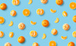 Colorful fruit pattern of fresh mandarin tangerine or clementine on blue background
