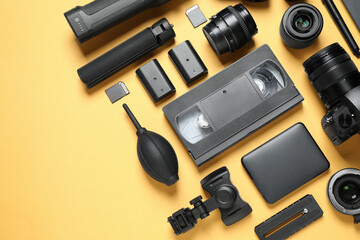 Wall Mural - flat lay composition with camera and video production equipment on yellow background. space for text