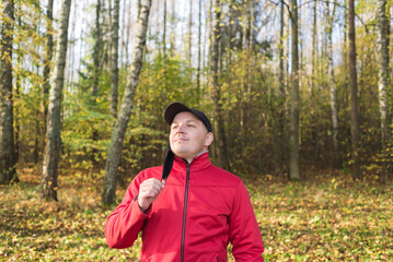 Young man takes off his mask outdoors. Portrait of a young man takes off his mask outdoors