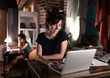 © Cavan Images - Female designer using laptop in workplace