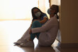 Two doctors in medical protective masks sit in corridor of medical facility. Medical error during operations concept