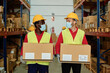 © Gabriel Trujillo - Multiracial warehouse workers holding delivery boxes while wearing safety mask for coronavirus prevention - Focus on faces