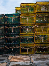 Green And Yellow Lobster Traps Stacked On The Stone Dock