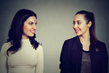 Portrait of two happy women looking at each other