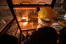 Worker Operates In The Cabin Of A Cargo Crane At The Steel Mill