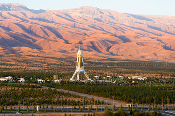 Kopet Dag Mountain Range and Neutrality Monument in Ashgabat, Turkmenistan. Also know as Turkmen-Khorasan mountains and Arch of Neutrality.