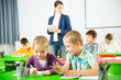 © JackF - Portrait of schoolchildren sitting in classroom and chatting during lesson. High quality photo