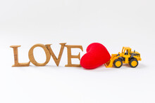 Love Wooden Font And Red Heart With Yellow Truck On White Background, Clearing And Old Love, Valentine Concept Background