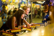 © SuperStock - Two female friends playing a game at an amusement park