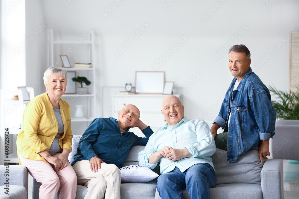 Senior people sitting on sofa at home