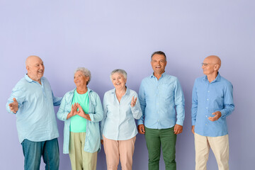 Wall Mural - Senior people on color background