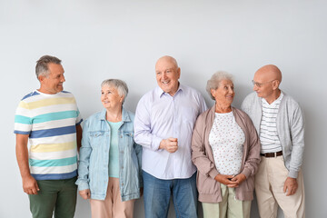 Wall Mural - Senior people near light wall in room