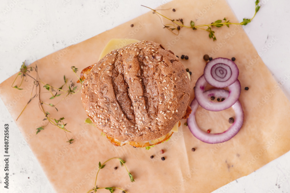 Tasty burger and spices on light background