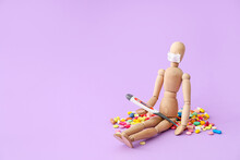 Wooden Mannequin Wearing Medical Mask With Pills And Electronic Thermometer On Color Background
