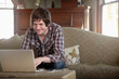 © SuperStock - A man working from home using a laptop.