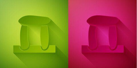 Wall Mural - Paper cut Stonehenge icon isolated on green and pink background. Paper art style. Vector.