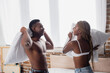 © LIGHTFIELD STUDIOS - Cheerful african american couple pillow fighting at home
