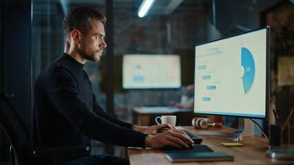 Poster - Young Handsome Project Manager Working on a Marketing Presentation on Desktop Computer in Busy Creative Office. Male Specialist is Implemeting Business Strategy Points Into the Keynote.