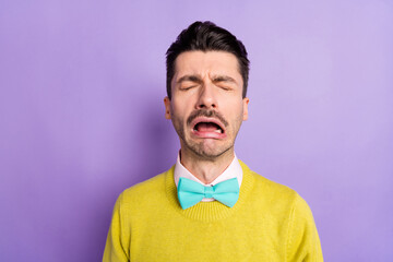 Wall Mural - Portrait of brunet crying guy wear yellow sweater isolated on pastel lilac color background