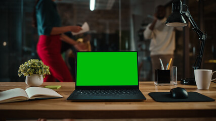 Aufkleber - Shot of a Laptop Computer with Green Screen Mock Up Display on a Desk in a Busy Creative Office Environment. Isolated Template for Any Media Type. Authentic Hipster Agency Vibe. 