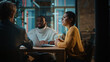 © Gorodenkoff - Young Creative Team Meeting with Business Partners in Conference Room Behind Glass Walls in an Agency. Colleagues Sit Behind Conference Table and Discuss Business, App User Interface and Design.