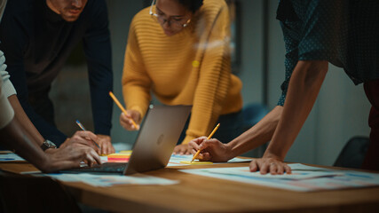 Aufkleber - Close Up of Diverse Multiethnic Team Having Conversation in Meeting Room in a Creative Office. Colleagues Lean On a Conference Table, Look at Laptop Computer and Make Notes with Pencils on Notebooks.
