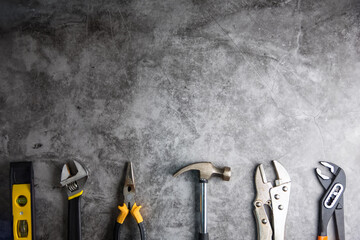 construction tools on gray-black cement floor background with copy space.home repair concept, repair