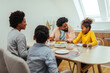 © bernardbodo - Cute afro family having lunch together at home