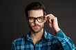 © Drobot Dean - Confident brutal guy in eyeglasses posing on camera