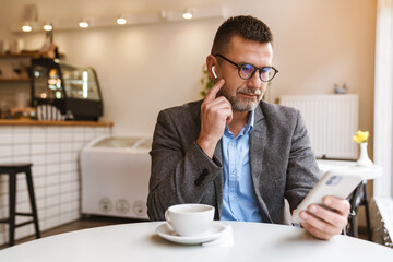 Young man texting message on smart phone