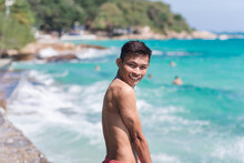Young Asian Man Smiles At Beach On Beautiful Island Of Koh Samet, Rayong, Thailand. Winter Vacation In Thailand.