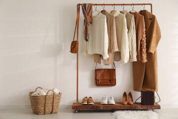 modern dressing room interior with rack of stylish shoes and women's clothes
